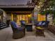 Inviting patio with comfortable seating, a fire pit, and ambient lighting for outdoor relaxation at 5441 Twilight Way, Parker, CO 80134