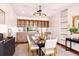 Formal dining room featuring hardwood floors and a custom lighted bar at 9150 E Center Ave # 9C, Denver, CO 80247