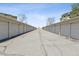 Row of detached garages with grey doors and roofs, seen from a cracked asphalt driveway at 9150 E Center Ave # 9C, Denver, CO 80247