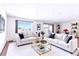 Bright and spacious living room with hardwood floors, couches and a glass coffee table at 9150 E Center Ave # 9C, Denver, CO 80247