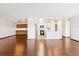 Open floor plan view, kitchen with white cabinets and stainless refrigerator, hardwood floor at 9150 E Center Ave # 9C, Denver, CO 80247