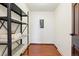 This pantry has a shelving unit, an electrical panel, and hardwood floors at 9150 E Center Ave # 9C, Denver, CO 80247