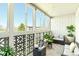 This sun room has white brick walls, tile floors, and lots of windows with views of the outdoors at 9150 E Center Ave # 9C, Denver, CO 80247