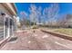 Spacious backyard patio with stone pavers, low brick walls, and outdoor access at 11730 Crow Hill Dr, Parker, CO 80134
