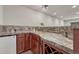 Basement bar area with marble counter top, sink, and wine rack at 11730 Crow Hill Dr, Parker, CO 80134