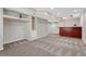 Finished basement with bar, built-in shelving, and neutral carpeting providing a versatile living space at 11730 Crow Hill Dr, Parker, CO 80134
