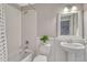 Cozy bathroom featuring a shower-tub combo, pedestal sink, and neutral decor at 11730 Crow Hill Dr, Parker, CO 80134