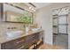 Elegant primary bathroom featuring double vanity, walk-in shower, and walk-in closet at 11730 Crow Hill Dr, Parker, CO 80134