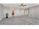 Carpeted primary bedroom with adjacent bath, walk-in closet and plant at 11730 Crow Hill Dr, Parker, CO 80134