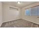 Bright bedroom with neutral paint, carpeted floor, and a large window providing natural light at 11730 Crow Hill Dr, Parker, CO 80134