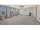 Large bedroom with three windows allowing natural light, carpet flooring, and ceiling fan at 11730 Crow Hill Dr, Parker, CO 80134