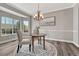 Cozy dining room features a round table on a patterned rug, complemented by a chandelier and bright natural light at 11730 Crow Hill Dr, Parker, CO 80134