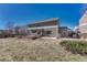 Backyard of home with brick patio, green siding, and a well-maintained lawn at 11730 Crow Hill Dr, Parker, CO 80134