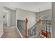 Bright hallway featuring carpet flooring, wrought iron banister, and a view of the front door at 11730 Crow Hill Dr, Parker, CO 80134