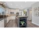 Charming kitchen with white cabinets, granite countertops, stainless steel appliances, and a central island with open shelving at 11730 Crow Hill Dr, Parker, CO 80134