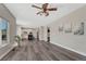 Spacious living room with an open floor plan, wood floors, and large windows offering ample natural light and backyard views at 11730 Crow Hill Dr, Parker, CO 80134