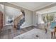 Spacious living room with hardwood floors, staircase, and views into dining room and office spaces at 11730 Crow Hill Dr, Parker, CO 80134