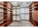 Spacious walk-in closet with custom shelves and hanging rods for organized storage at 11730 Crow Hill Dr, Parker, CO 80134