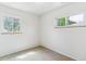 Bright bedroom featuring neutral carpet, white walls and natural light from two windows at 2767 S Linley Ct, Denver, CO 80236