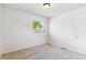 Bright bedroom with neutral carpet, white walls, and large window at 2767 S Linley Ct, Denver, CO 80236