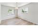 Bright dining room with wood floors and ample natural light from two windows at 2767 S Linley Ct, Denver, CO 80236