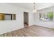 Bright dining room featuring modern wood floors and an open layout with updated lighting at 2767 S Linley Ct, Denver, CO 80236