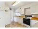 Traditional kitchen with white cabinets, laminate countertops, and matching appliances at 2767 S Linley Ct, Denver, CO 80236