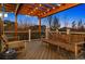 Inviting outdoor deck with wood-burning lights and stylish wicker seating, perfect for relaxing evenings at 12187 S Hidden Trail Ct, Parker, CO 80138