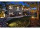 Lush backyard with stone patio, outdoor seating, firepit, upper deck, expansive lawn, and tranquil landscaping at 12187 S Hidden Trail Ct, Parker, CO 80138
