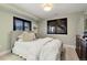Neutral bedroom featuring two windows with privacy shutters and queen-sized bed at 12187 S Hidden Trail Ct, Parker, CO 80138