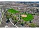 Scenic aerial view of community park with baseball and soccer fields, winding pathways, and lush greenery at 12187 S Hidden Trail Ct, Parker, CO 80138