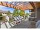 Outdoor deck with overhead pergola and seating overlooking backyard at 12187 S Hidden Trail Ct, Parker, CO 80138