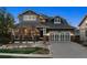 Charming two-story home featuring stone accents, a two-car garage, and a well-manicured front yard at 12187 S Hidden Trail Ct, Parker, CO 80138