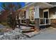 Inviting front porch with stone pillars, stone steps, and manicured landscaping creating excellent curb appeal at 12187 S Hidden Trail Ct, Parker, CO 80138