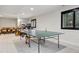 Game room features a ping pong table, with a living room in the background at 12187 S Hidden Trail Ct, Parker, CO 80138