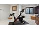 Brightly lit home gym with Peloton bike, weights, and window at 12187 S Hidden Trail Ct, Parker, CO 80138