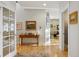 Inviting hallway with hardwood floors and decorative furnishings, leading to bright and open living spaces at 12187 S Hidden Trail Ct, Parker, CO 80138