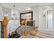 Hallway view with black metal railing, artwork, and modern lighting fixture at 12187 S Hidden Trail Ct, Parker, CO 80138
