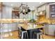Kitchen featuring a center island with a farm sink, stainless steel appliances, and light countertops at 12187 S Hidden Trail Ct, Parker, CO 80138