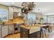 Spacious kitchen featuring a center island, stainless steel appliances, and light countertops at 12187 S Hidden Trail Ct, Parker, CO 80138
