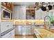 Bright kitchen with stainless steel appliances, under cabinet lighting, and light wood floors at 12187 S Hidden Trail Ct, Parker, CO 80138