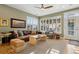 Cozy living room with a leather sofa, ceiling fan, plantation shutters, and natural light at 12187 S Hidden Trail Ct, Parker, CO 80138