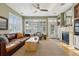 Comfortable living room featuring a fireplace, plush seating, and views to the outdoor area at 12187 S Hidden Trail Ct, Parker, CO 80138