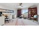 Bright home office featuring bookshelves, white desk, ceiling fan, and ample natural light at 12187 S Hidden Trail Ct, Parker, CO 80138