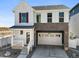 Charming two-story home with white siding, stone accents, a two-car garage, and a welcoming front porch at 1917 S Fultondale Way, Aurora, CO 80018