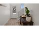 Bright foyer with a plant, a bench, hardwood floors, and a view of the front door at 1917 S Fultondale Way, Aurora, CO 80018