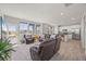 Open-concept living room and kitchen with hardwood floors, stainless steel appliances, and lots of natural light at 1917 S Fultondale Way, Aurora, CO 80018