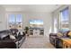 Comfortable living room featuring hardwood floors, large windows, and a stylish entertainment center at 1917 S Fultondale Way, Aurora, CO 80018