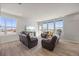 Spacious living room with comfortable seating, large windows, and access to the outdoor balcony at 1917 S Fultondale Way, Aurora, CO 80018