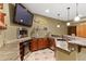 This basement wet bar features granite countertops, a beverage fridge, stainless appliances, and a television at 9009 Rambling Oak Pl, Parker, CO 80134